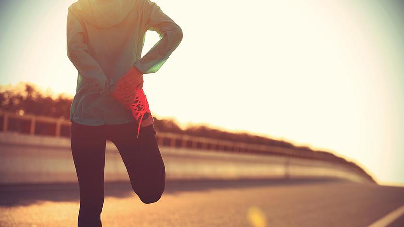 Woman stretching outdoors during workout